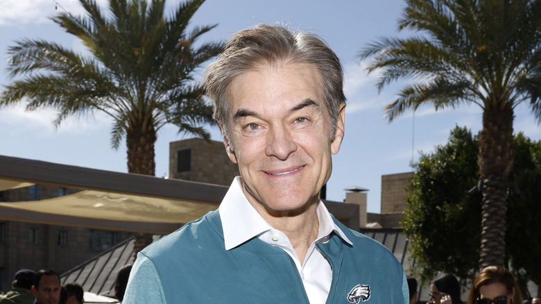 Dr. Oz near palm trees