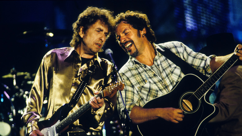 Bob Dylan and Bruce Springsteen onstage with guitars and microphone